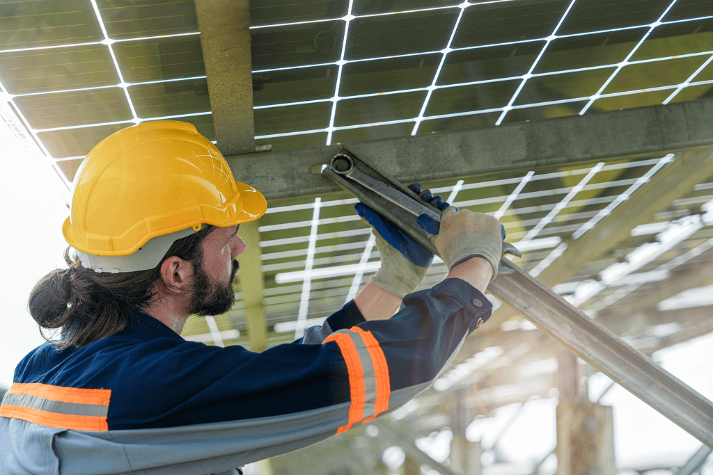 Worker in a yellow hard hat repairing or installing a skylight, showcasing expertise in home improvement and energy efficiency.