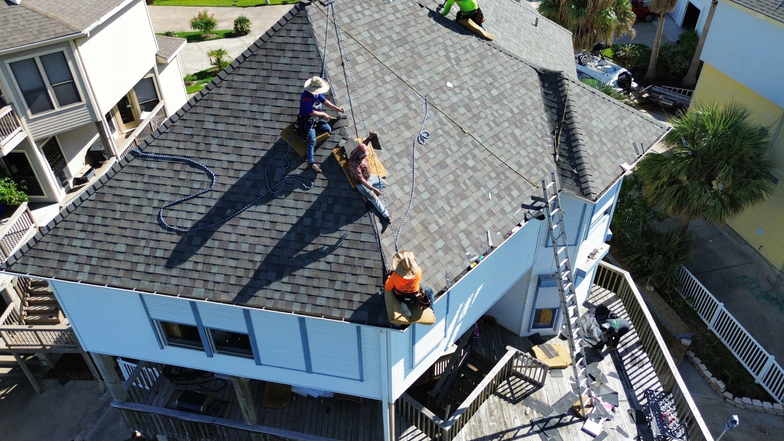 Roofing crew performing installation on a residential property in Texas, showcasing quality craftsmanship and exterior remodeling expertise by Tekton Exteriors.